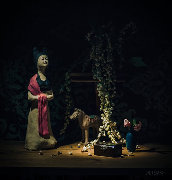 A still life setup with stuff and a clay figurine I made